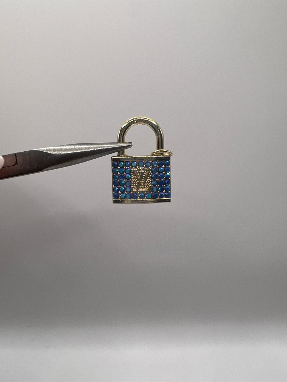 1488. Gold-Tone Padlock Charm with Blue Crystal Accents